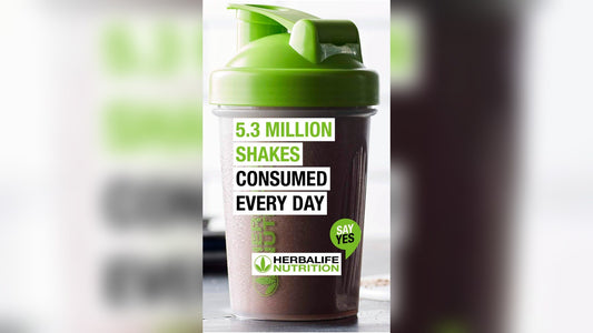 A green and black shaker bottle with text promoting daily herbalife protein shake consumption.