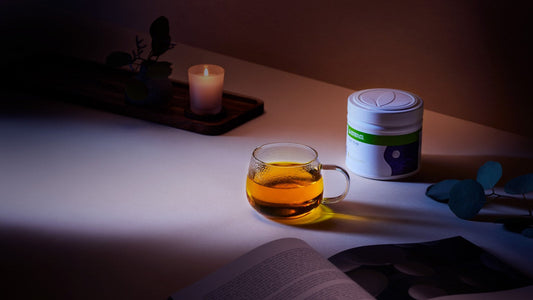 Herbalife Night Mode Chamomile and Peach tub next to a warm evening drink in a mug
