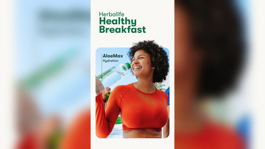 Person with curly hair holds a water bottle against a cheerful outdoor breakfast scene.