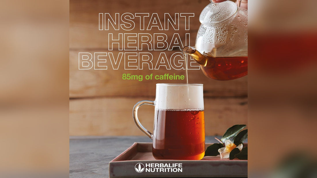 Herbal beverage with caffeine in a glass cup, pouring from a teapot on a wooden surface