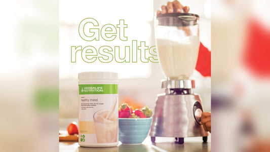 Person blending a smoothie with herbal nutrition supplement, bright kitchen setting, healthy vibe