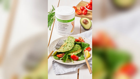 Herbalife Formula 3 Personalised Protein Powder tub with a scoop of powder being added to a shake